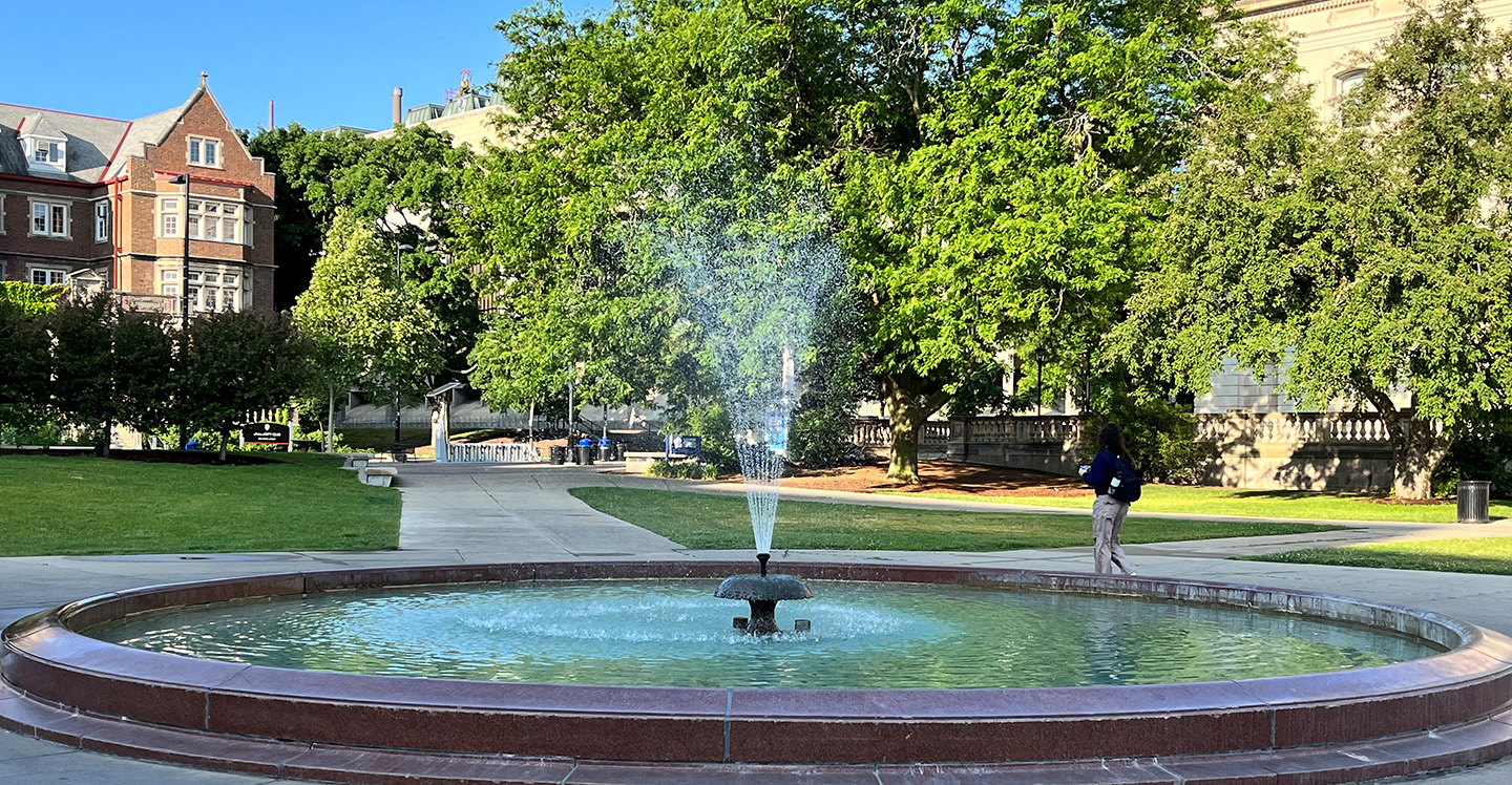 Student by a fountain on the campus of the University of Wisconsin-Madison 