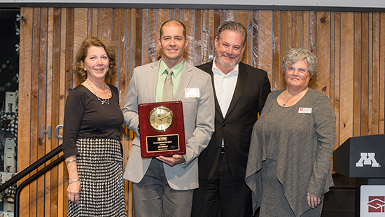 Aric Kirkland, 2023 MHEC Outstanding Service Award recipient. He is pictured with MHEC staff holding his award.