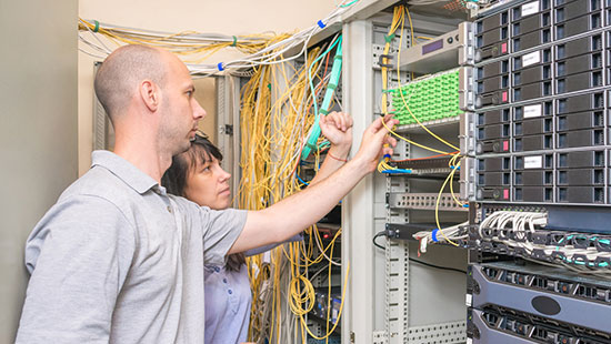 man and woman working with technology