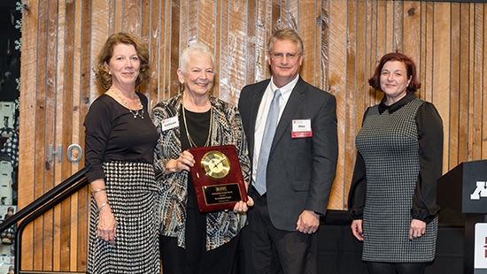 Dr. Kathleen Fimple 2023 Outstanding Service Award recipient. She is pictured with MHEC staff and CCPE Executive Director Mike Baumgartner holding her award.