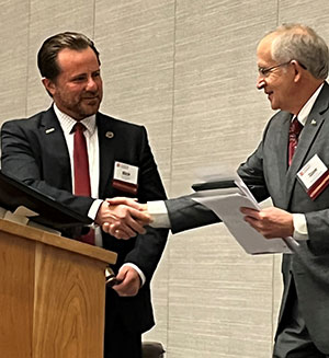 L to R: Rep. Rick Carfagna (OH) receives the MHEC gavel from Dr. David Eisler (MI), outgoing chair.